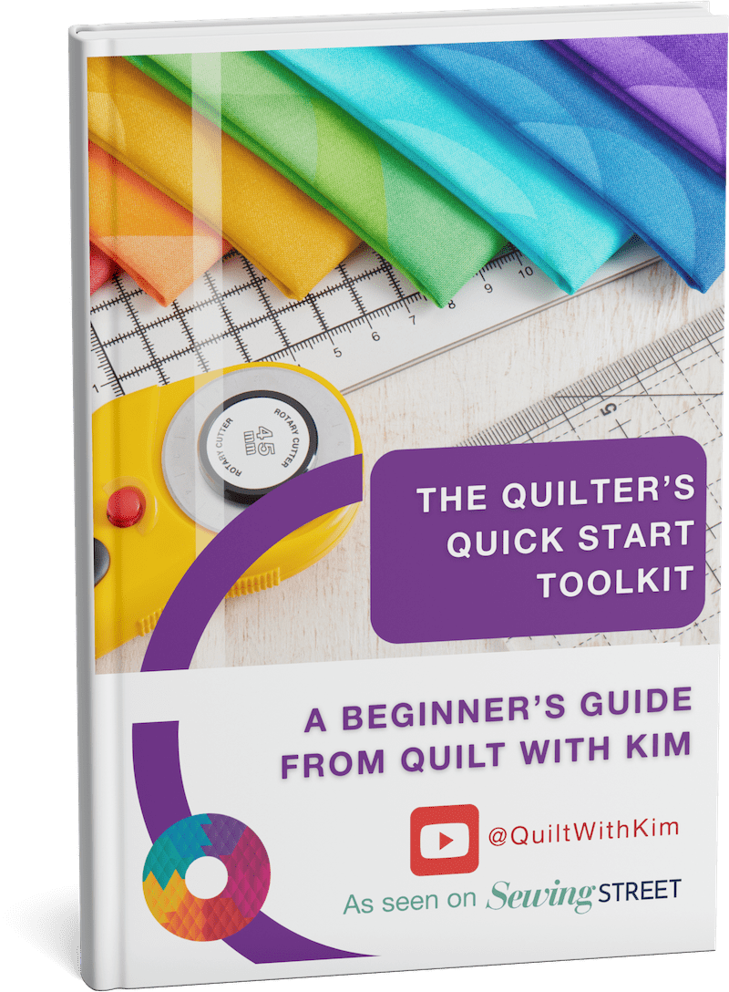 Book cover titled The Quilter’s Quick Start Toolkit: A Beginner’s Guide from Quilt With Kim, featuring colorful fabric, a rotary cutter, ruler, and social media and Sewing Street logos.