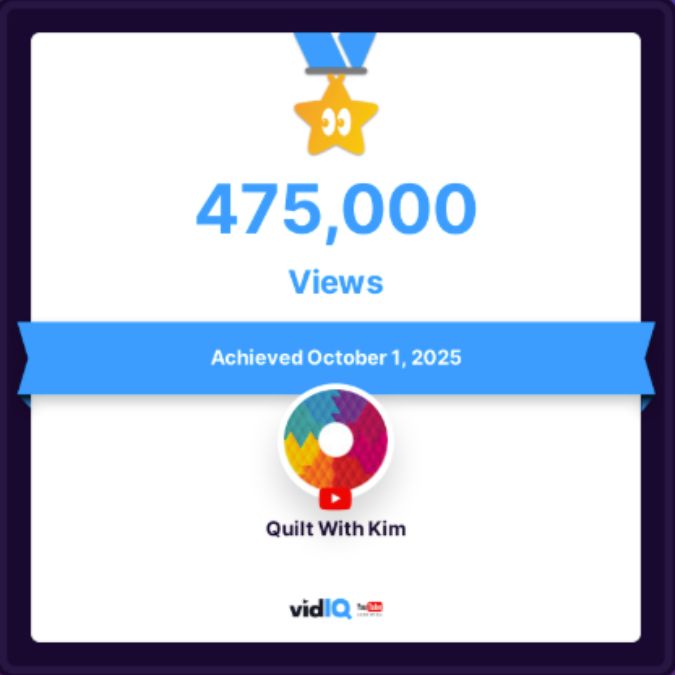 A digital certificate shows a gold star with an eye icon, 425,000 VIEWS, and “Achieved July 14th, 2025.” The channel name “Quilt With Kim” appears with the vidIQ logo below.