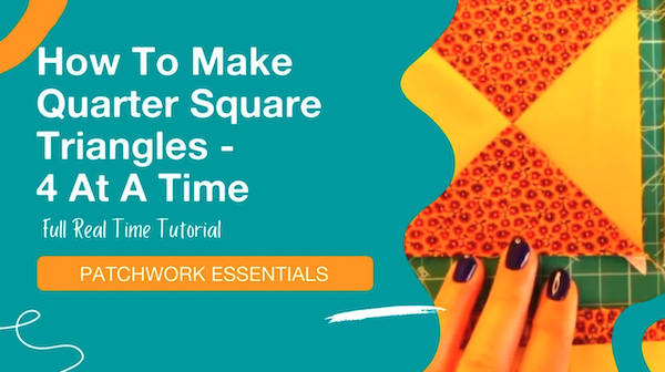 Image with text: How To Make Quarter Square Triangles - 4 At A Time. Full Real Time Tutorial. Patchwork Essentials. A hand with dark nail polish holds colorful quilted fabric pieces arranged in triangles.