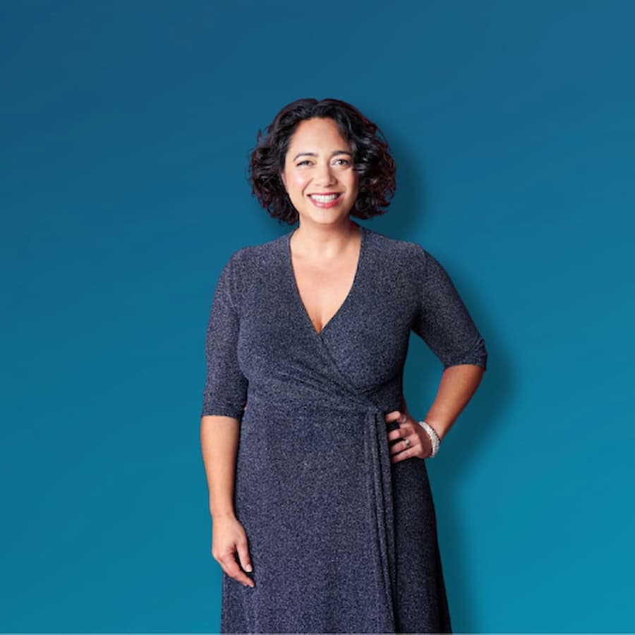 Alena Bennett, CFO Success Partner in a sparkly blue V-neck dress