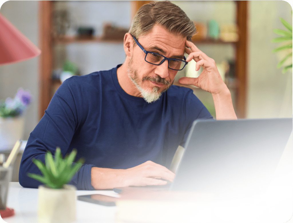 Worried man at laptop reflecting on mortgage stress and financial pressure, seeking a fresh financial start