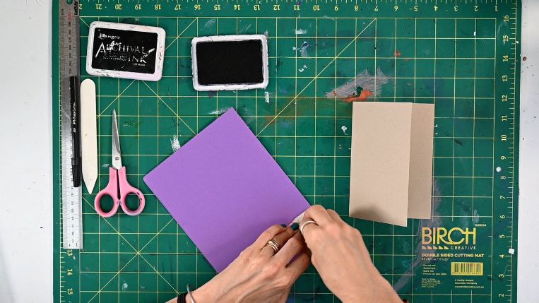 stamp over purple paper stamp over purple paper